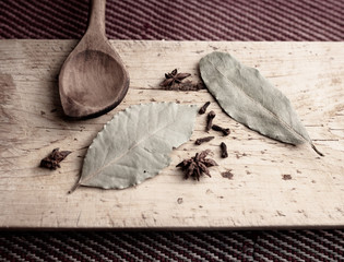 Herbal and black tea leaves decorating a wooden board