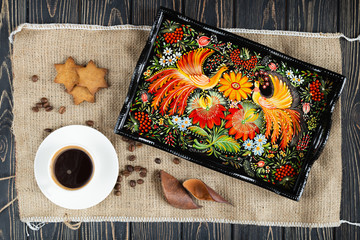 Wall Mural - Ukrainian Petrykivka tray, traditional decorative painting style, handicraft souvenirs on a sackcloth background, top view