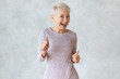 © Anatoliy Karlyuk - Funny cheerful middle aged blonde woman wearing elegant pencil dress dancing and showing thumbs up gesture as sign of approval, celebrating success or profitable deal, smiling broadly at camera