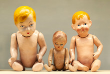 Very Old Naked And Broken Toy Babies. Old And Vintage Dolls That Girls Used To Play With. Concept Of Nostalgia And Memories Of A Past Time.