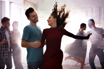 Poster - Lovely young couple dancing together at party