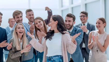 happy businesswoman standing in front of her team.