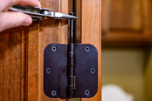 Oiled Bronze Door Hinge With Pin Being Removed
