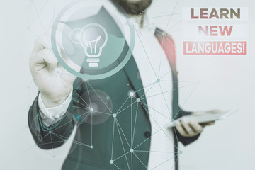 Poster - Handwriting text writing Learn New Languages. Conceptual photo developing ability to communicate in foreign lang Male human wear formal work suit presenting presentation using smart device