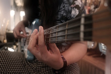 Young Musician Playing Electric Guitar Bass, Play The Music Instruments. With Soft Focus And Selective Focus