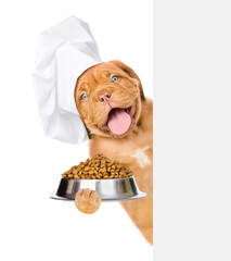 Poster - Funny dog wearing a chef's hat holds bowl of dry dog food behind empty banner. isolated on white background