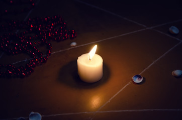 Wall Mural - pentagram is painted on the floor, candles are lit, beads are lying, shells are scattered. concept of magic with occult and esoteric symbols.