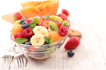 Wall Mural - fresh fruit salad with banana, melon and berry