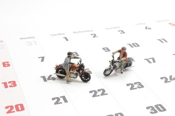 Close up of two traveler miniature figure ride motocycle