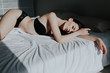 © dmitriisimakov - beautiful woman in underwear lies on the bed in the bedroom