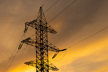 Electrical transmission tower iron high sunset sky yellow clouds