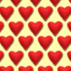 Wall Mural -  Holiday texture of the red felt hearts with white threads. Symbol of love with large stitches on an yellow background.