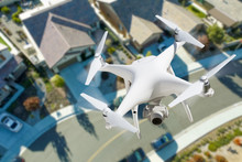 Unmanned Aircraft System Quadcopter Drone In The Air Over Residential Neighborhood