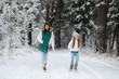 © alexkich - Young family for a walk. Mom and daughter are walking in a winter park.