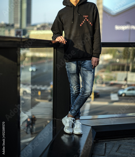 Teenager wearing a pair of white Nike Huarache, denim and hoodie - Buy this  stock photo and explore similar images at Adobe Stock | Adobe Stock