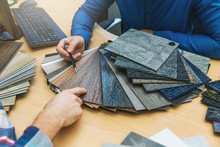 Interior Design - Customer Choosing Floor Material From Samples At Flooring Shop
