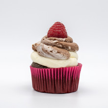 Chocolate Cupcake With Frosting And Raspberry Garnish