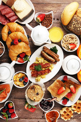 Breakfast served with coffee, orange juice, croissants, cereals and fruits. Balanced diet. Continental breakfast with granola and fruits