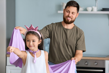 Father with little daughter playing at home