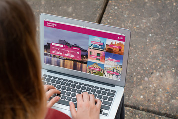 Woman with laptop booking a hotel on website