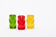 © Cagkan - Three colorful gummy bears standing on white background with copy space