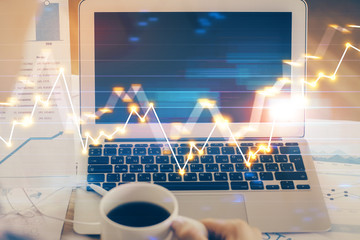 Stock market graph and table with computer background. Double exposure. Concept of financial analysis.