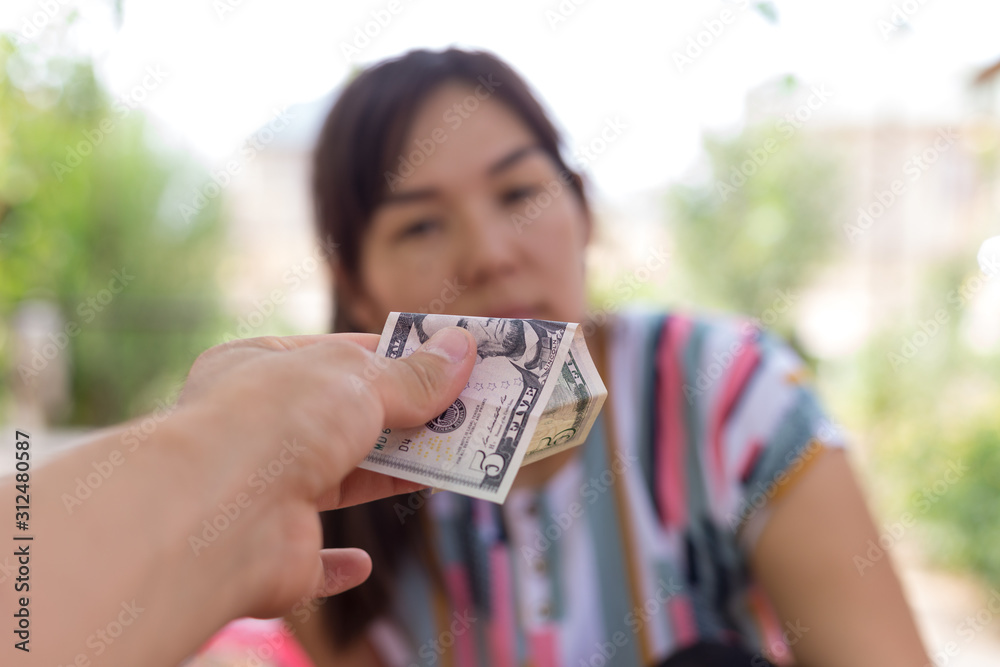 Offer dollar bills. A man offers a girl money for sex Stock Photo | Adobe  Stock