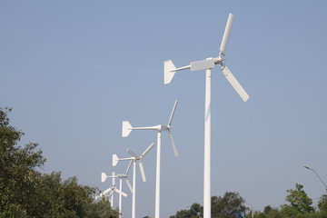 Windmill on blue sky background