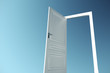© peshkova - Open door on a blue sky background.