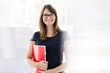 © moodboard - Portrait of smiling businesswoman holding document at office