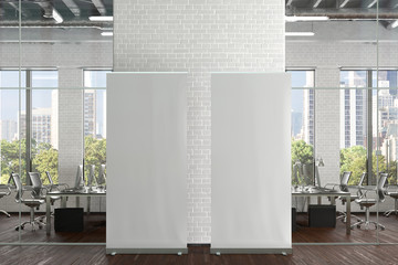 blank roll up banner stands in white brick office interior. 3d illustration