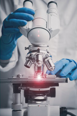 Wall Mural - close-up shot of microscope with metal lens.