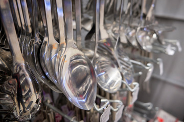 Chrome colored spoons and other different kinds of kitchenware