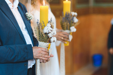 Wall Mural - groom holding candle with dry flowers