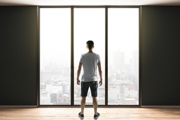 Poster - man in shorts standing in contemporary interior