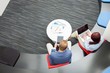 © MDBPIXS - High angle view of business people using technologies in office