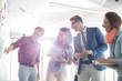 © MDBPIXS - Smiling businessman explaining to colleagues in creative office