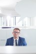 © MDBPIXS - Portrait of confident businessman with speech bubble in office