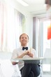 © MDBPIXS - Happy businessman looking away in creative office