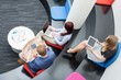 © MDBPIXS - High angle view of business people sitting in office lobby