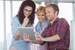 © MDBPIXS - Businesswomen with male colleague using tablet PC in creative office