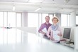 © MDBPIXS - Portrait of confident business people standing in office