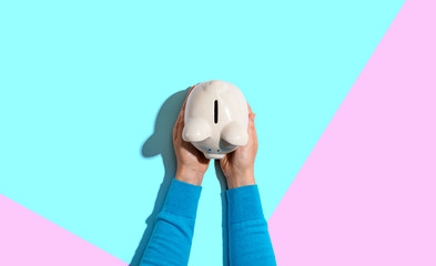 Person holding a piggy bank from above