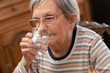 © thodonal - Elderly woman drinking water