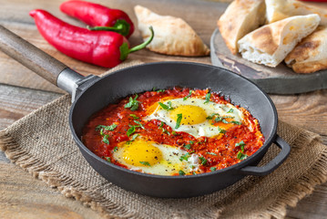 Wall Mural - Shakshouka served in a frying pan