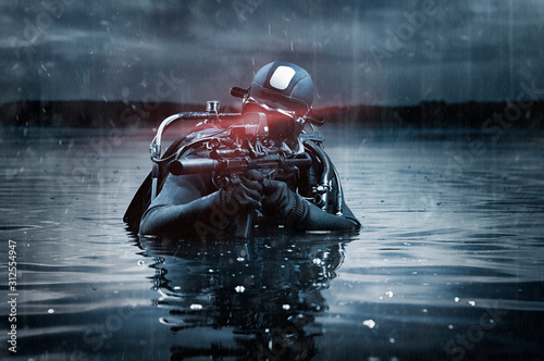 Fotomural SWAT unit soldier stands waist-deep in water with a machine gun in his hands