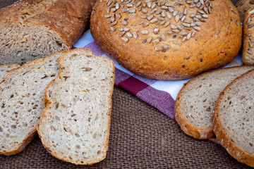 Fresh bread on table. Baked dark bread and sliced bread.