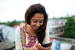 © SAPTAK GANGULY/Stocksy - Girl busy with smartphone at the rooftop