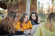 © Javier Pardina/Stocksy - group of students studying in the park