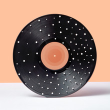 Black Vinyl Record With White Spots On A Duotone Background.